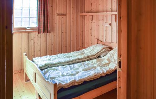 a bunk bed in a wooden room with a window at Bjertnes Turistgrd in Noresund