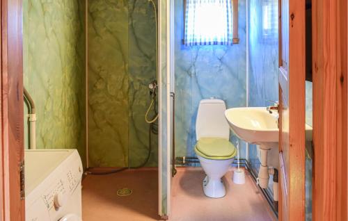 a bathroom with a toilet and a sink at Bjertnes Turistgrd in Noresund