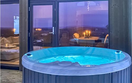 a large blue tub in a room with a view at Lovely Home In Hnefoss With Kitchen in Hønefoss