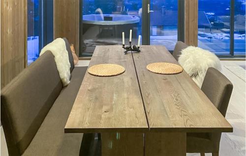 a wooden table with two candles on top of it at Awesome Home In Hønefoss With Wifi in Hønefoss