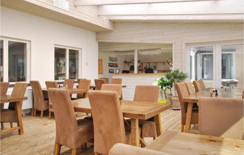 a dining room with wooden tables and chairs at Gorgeous Home In Kosta With Wifi in Kosta