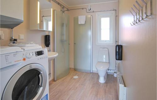 a bathroom with a washing machine and a toilet at Awesome Home In Kosta With Wifi in Kosta