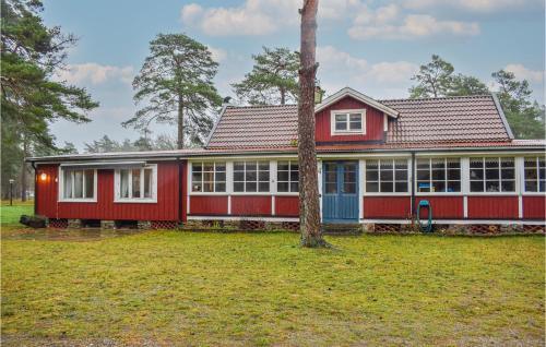 a red house with a tree in front of it at 4 Bedroom Gorgeous Home In Borgholm in Borgholm