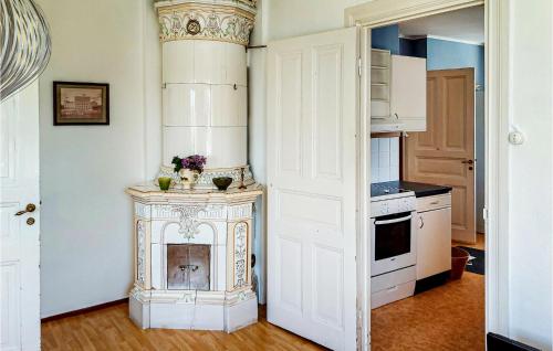 a kitchen with a fireplace in the corner of a room at 4 Bedroom Gorgeous Home In Degerhamn in Degerhamn