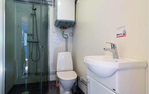 a bathroom with a toilet and a sink and a shower at 1 Bedroom Amazing Home In Slite in Slite