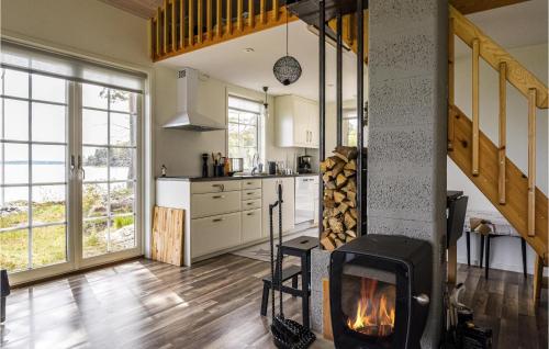 a kitchen with a fireplace in the middle of a room at 3 Bedroom Beautiful Home In Lidköping in Lidköping