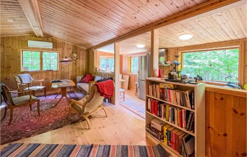a living room with a book shelf and a desk at Gorgeous Home In Mollaryd With Wifi in Mollaryd
