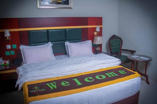a bedroom with a bed with a welcome sign on it at Best Lodge in Tamale