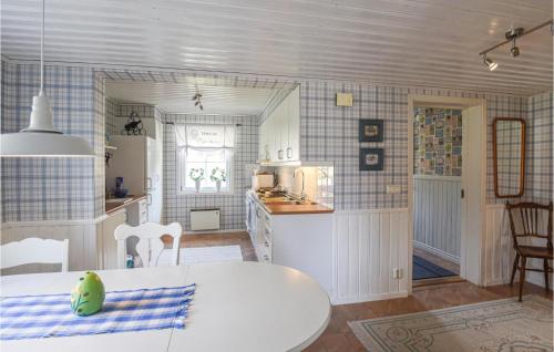 a kitchen with a white table in a room at Beautiful Home In Undenäs in Undenäs