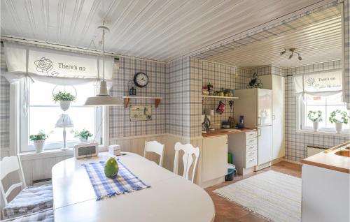 a kitchen and dining room with a table and chairs at Beautiful Home In Undenäs in Undenäs