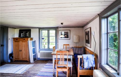 a dining room with a table and chairs at Amazing Home In Lidköping With Kitchen in Lidköping