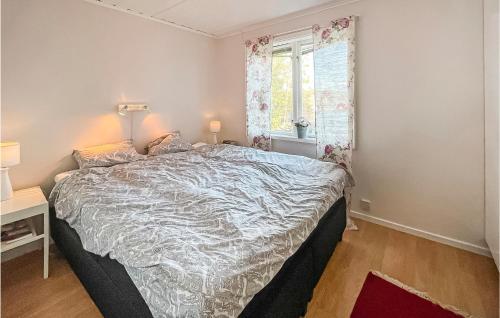 a bedroom with a large bed and a window at Nice Home In Bredared With Wifi 