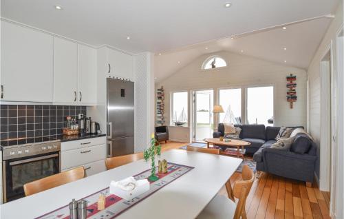 a kitchen and living room with a couch and a table at Stunning Home In Mellerud in Mellerud