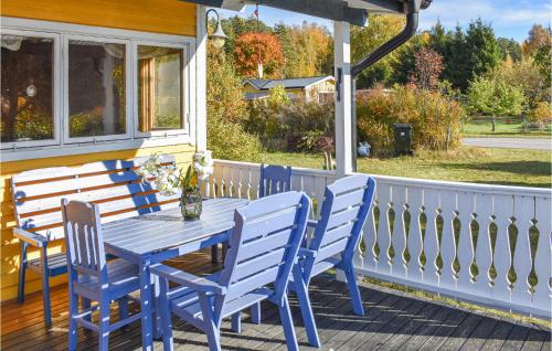 a blue table and chairs on a porch at 2 Bedroom Stunning Home In Kolmården in Kolmården