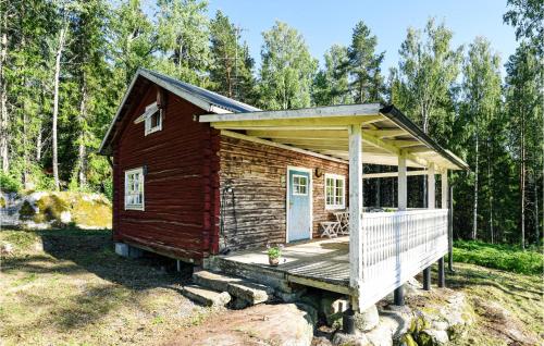 a small log cabin with a porch and a deck at 1 Bedroom Awesome Home In Åmotfors in Åmotsfors