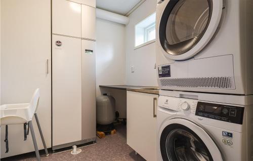 a laundry room with a washer and a dryer at Stunning Home In Svanskog With Sauna in Svanskog