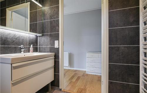 a bathroom with a sink and a mirror at Stunning Home In Svanskog With Sauna in Svanskog