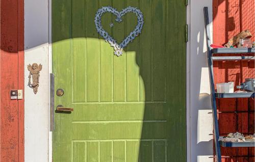 una puerta verde con un corazón pintado en ella en Stunning Apartment In ngelsberg With Kitchen, en Ängelsberg