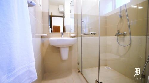 a bathroom with a sink and a glass shower at The Beach Front Apartment - Colombo, Uswetakeiyawa, Colombo in Wattala