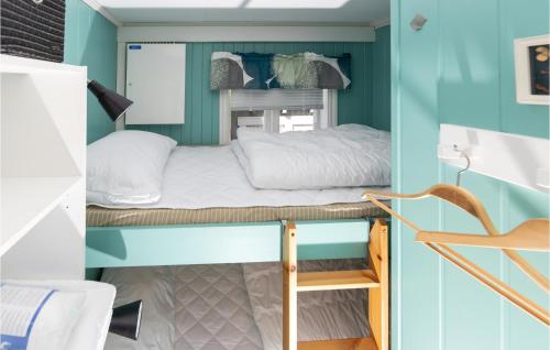 a bunk bed in a small room with blue walls at Beautiful Home In Isfjorden With 2 Bedrooms And Wifi in Isfjorden