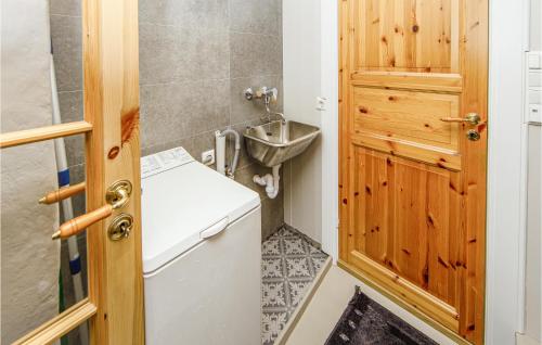 a small bathroom with a sink and a washing machine at Nice Apartment In farnes With House Sea View in Åfarnes