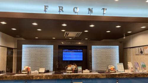 a lobby of a hotel with a television and a counter at Toyoko Inn Shizuoka eki Minami guchi in Shizuoka