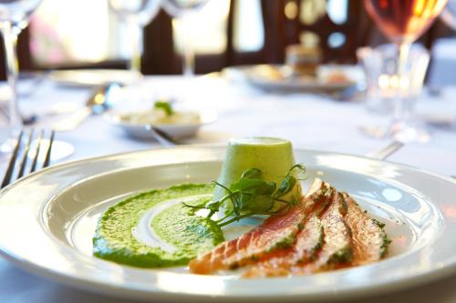 a white plate with some food on a table at The Wrea Head Hall Country House Hotel & Restaurant in Scarborough