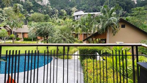 a house with a fence and some trees at Aonang Hill Krabi-SHA Extra Plus in Ao Nang Beach