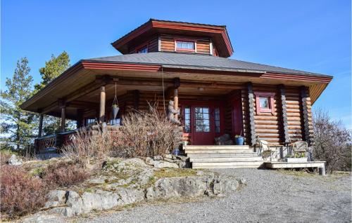 a log cabin with a red door on a mountain at Gorgeous Home In Vegårshei With Wifi in Vegårshei