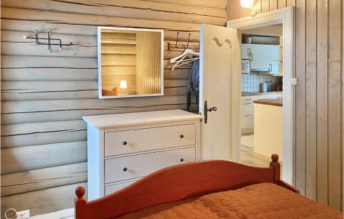 a bedroom with a dresser and a mirror on a wall at 4 Bedroom Lovely Home In l in Ål