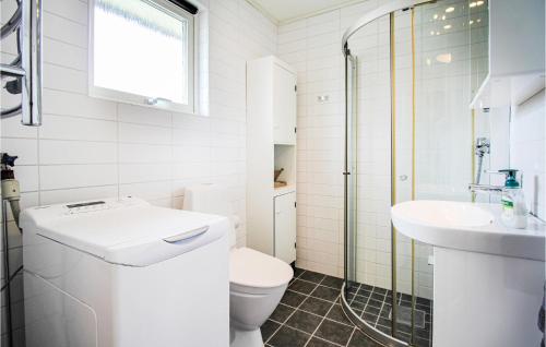 a white bathroom with a toilet and a sink at 1 Bedroom Stunning Home In Viken in Viken