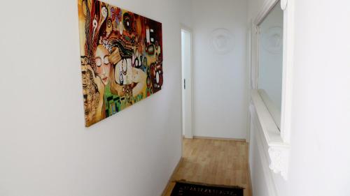 a hallway with a painting hanging on a wall at Villaci Business Apartments in Leimen