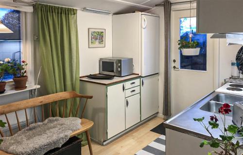 a small kitchen with a microwave on a counter at 2 Bedroom Cozy Home In Ramdala in Möcklö