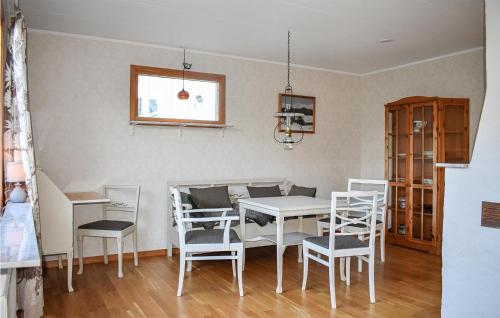 a dining room with a white table and chairs at Cozy Home In Karlskrona With Kitchen in Karlskrona