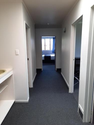 an empty room with a hallway leading to a bedroom at Manowhenua Lodge in National Park