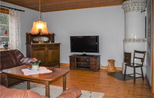 a living room with a couch and a tv at Stunning Home In Mörrum With Wifi in Mörrum