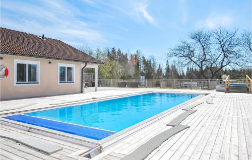 a swimming pool in the yard of a house at Nice Home In Kosta With Wifi in Kosta