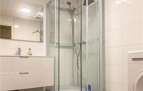 a shower with a glass door in a bathroom at Awesome Home In Krkrhamn With House Sea View in Engenes