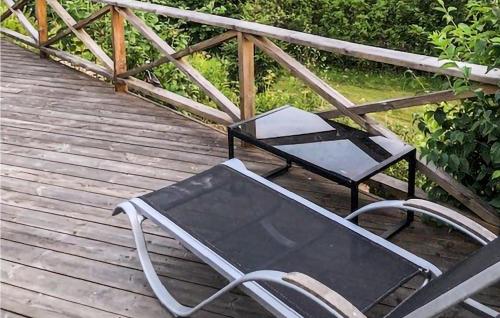 two chairs and a table on a wooden deck at 3 Bedroom Stunning Home In Lekeryd in Lekeryd