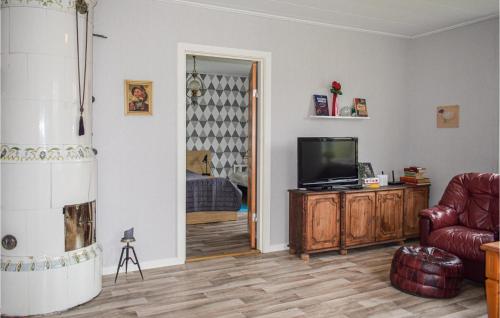 a living room with a television and a couch at 2 Bedroom Gorgeous Home In Landsbro in Landsbro
