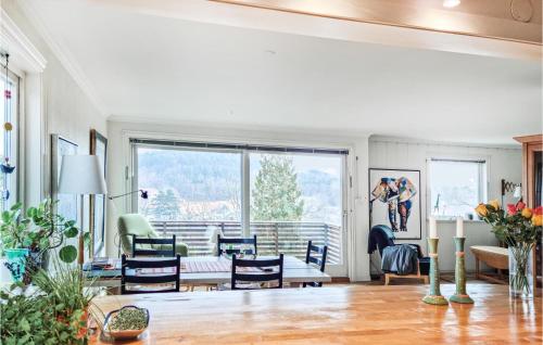 a living room with a table and chairs at Stunning Home In Kristiansand in Kristiansand