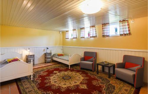 Habitación con sillas, cama y chimenea en Awesome Home In Hjlteby With Wifi en Hjälteby