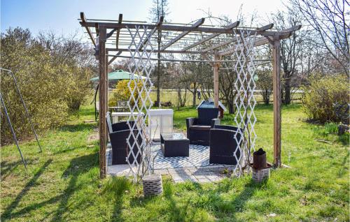 a pergola with a table and chairs in a yard at 3 Bedroom Cozy Home In Ålem in Ålem