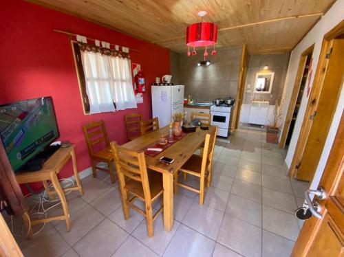 a kitchen and dining room with a table and chairs at Aires de Tafi in Tafí del Valle