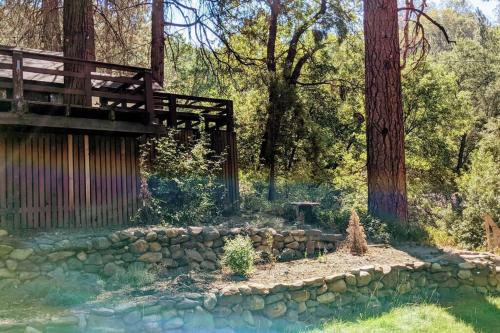 a garden with a bridge and a stone wall at Pierce's Cabin in Miramonte