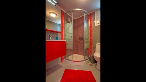 a red bathroom with a toilet and a shower at Cozy Apartment Amoudara Heraklion Crera-4 in Ayía Marína