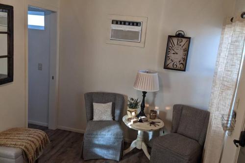 a living room with two chairs and a table at Cozy Cabin in Squaw Valley