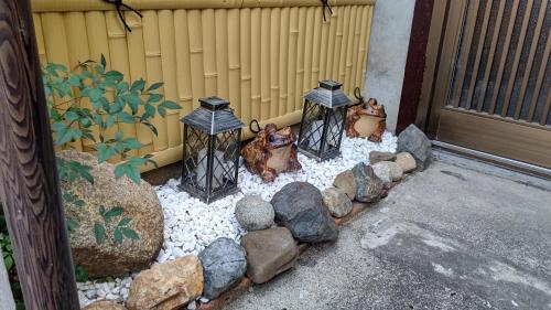 a bird feeder with three birds in a garden at Kyoto Osaka SUMIREYA in Takatuki