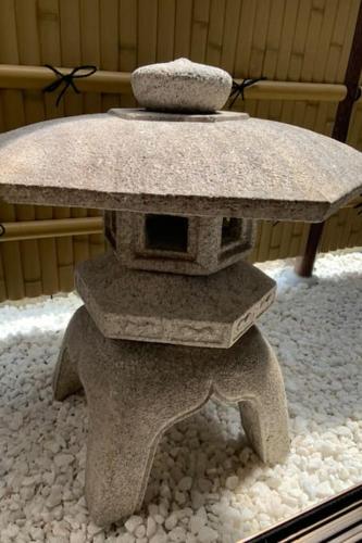 a stone table with a vase on top of it at Kyoto Osaka SUMIREYA in Takatuki