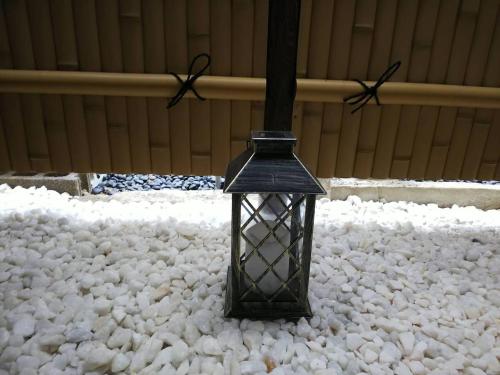 a black lantern sitting on top of a pile of snow at Kyoto Osaka SUMIREYA in Takatuki